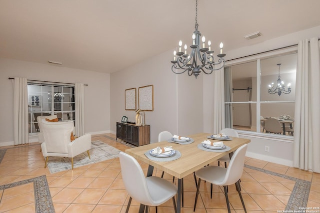 dining space with a chandelier, visible vents, and light tile patterned floors