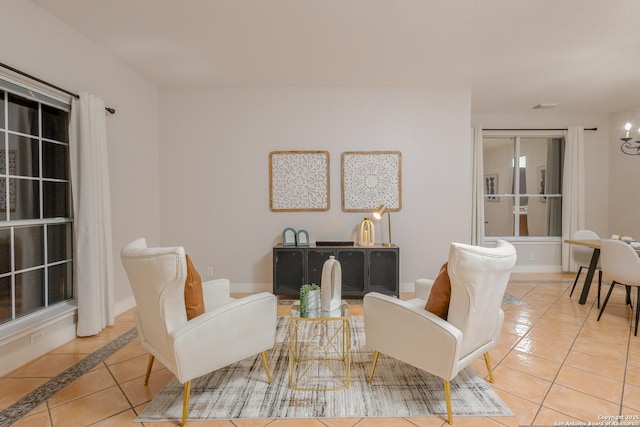 sitting room featuring tile patterned flooring and baseboards