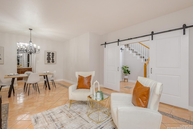 sitting room featuring a chandelier, light tile patterned floors, baseboards, and a barn door