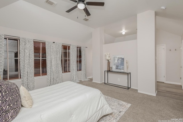 carpeted bedroom with baseboards, visible vents, and vaulted ceiling