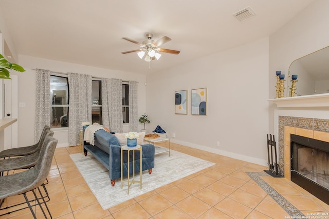 living area with visible vents, a fireplace, baseboards, and light tile patterned floors