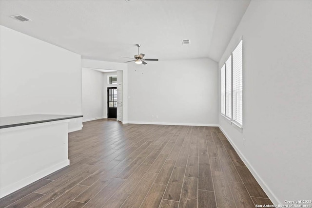 empty room with dark wood finished floors, visible vents, and a ceiling fan