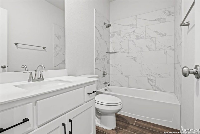 bathroom featuring  shower combination, wood finish floors, vanity, and toilet