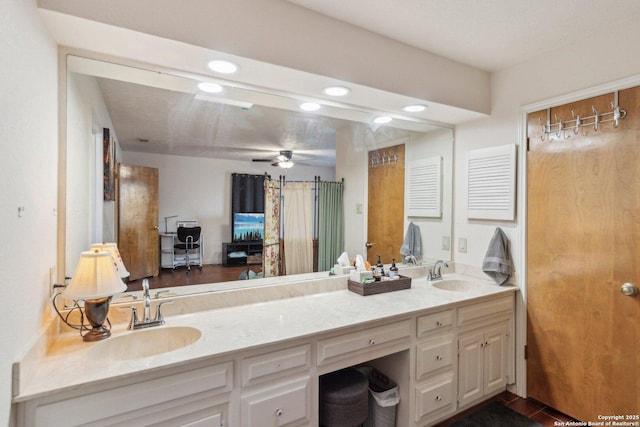 bathroom with recessed lighting, a sink, and double vanity