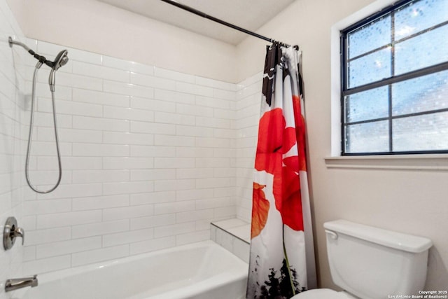 bathroom featuring shower / bath combination with curtain and toilet