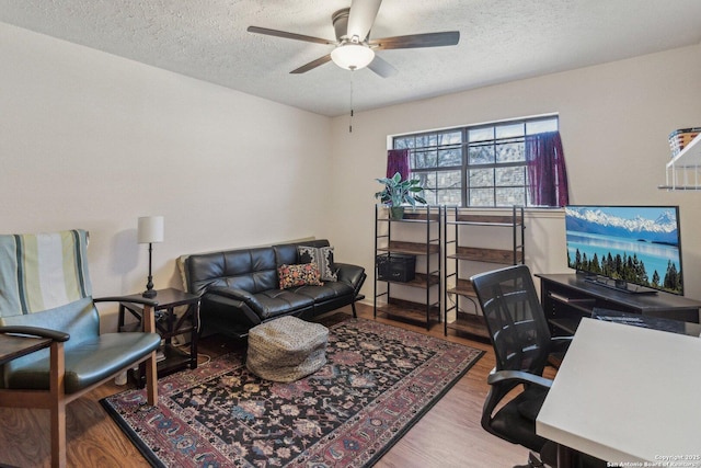 office area featuring a textured ceiling, wood finished floors, and a ceiling fan