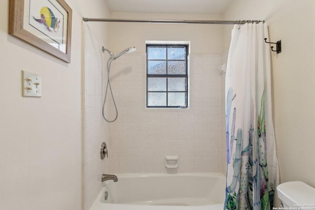 bathroom with shower / bath combo and toilet