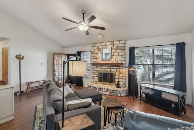 living room with lofted ceiling, a fireplace, a ceiling fan, and wood finished floors