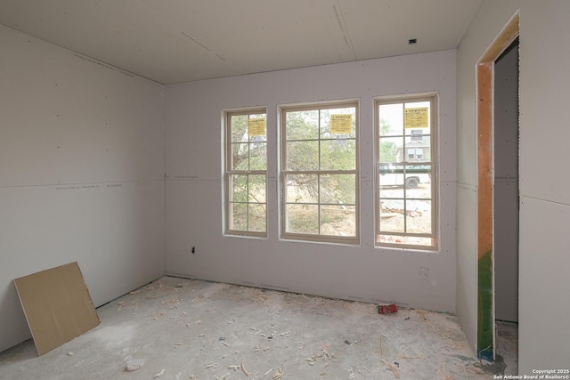 unfurnished room featuring a wealth of natural light
