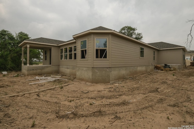 view of home's exterior with a shingled roof