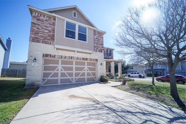 view of front of house featuring concrete driveway, a front yard, fence, a garage, and stone siding