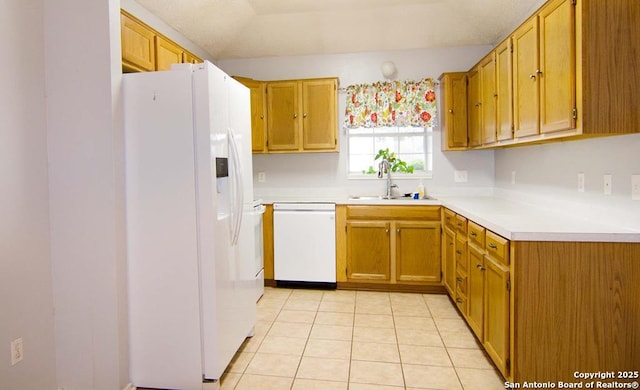 1102 E Hancock, Beeville, TX 78102 - kitchen featuring dishwashing machine, white fridge with ice dispenser, a sink, light countertops, and light tile patterned floors