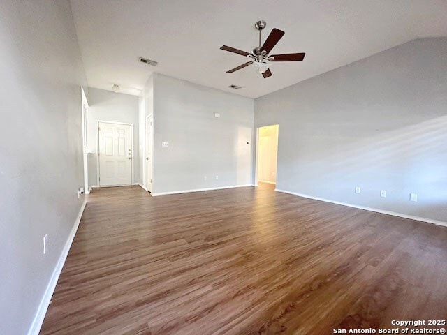 1102 E Hancock, Beeville, TX 78102 - unfurnished room with vaulted ceiling, baseboards, ceiling fan, and dark wood-type flooring