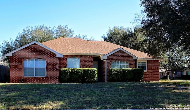 1102 E Hancock, Beeville, TX 78102 - ranch-style home with brick siding, a front yard, and a shingled roof