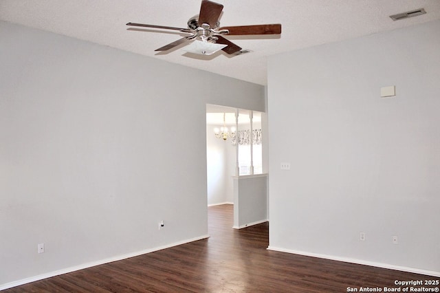 1102 E Hancock, Beeville, TX 78102 - empty room with a ceiling fan, a chandelier, dark wood-style floors, and baseboards