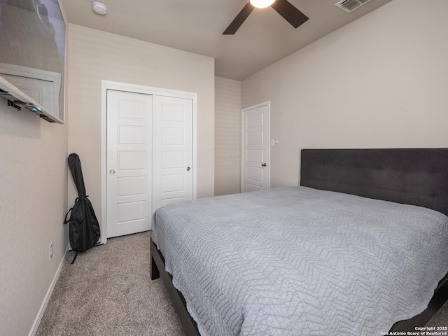 carpeted bedroom with a closet, visible vents, ceiling fan, and baseboards