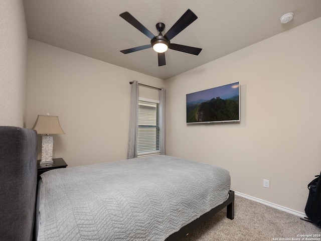 carpeted bedroom featuring a ceiling fan and baseboards