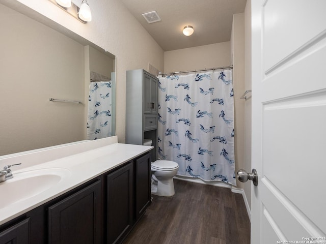 full bathroom featuring toilet, shower / tub combo, wood finished floors, vanity, and visible vents