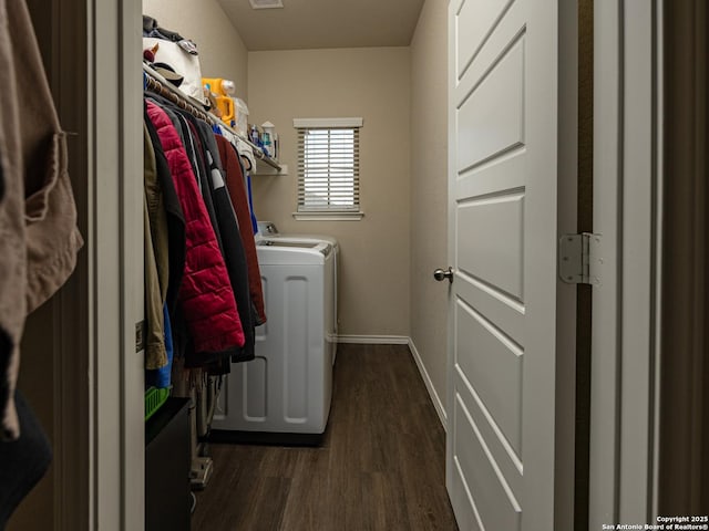 washroom featuring laundry area, baseboards, separate washer and dryer, and dark wood-type flooring