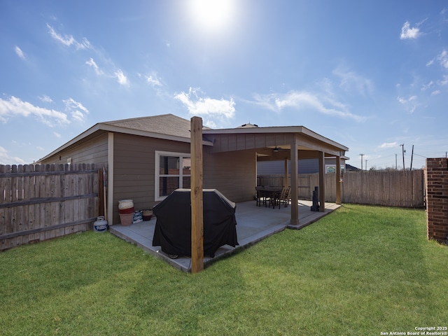 back of property featuring ceiling fan, a lawn, a patio area, and a fenced backyard