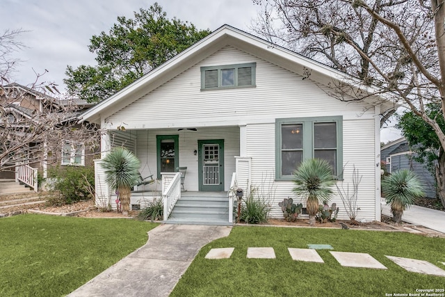 bungalow-style house featuring a porch and a front yard