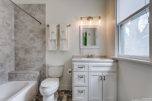 full bathroom with toilet, bathing tub / shower combination, baseboards, and vanity