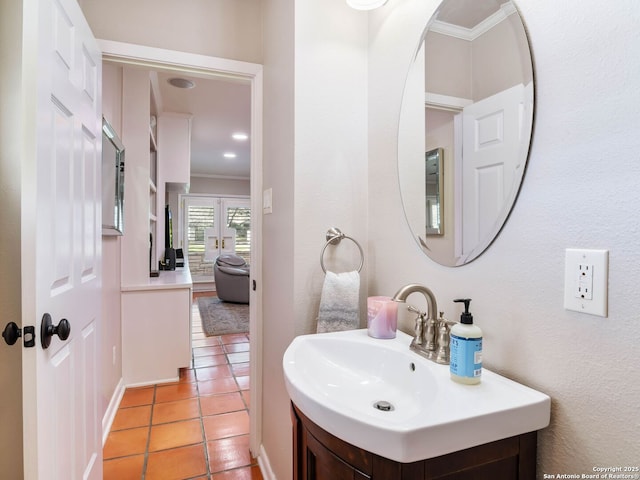 bathroom featuring tile patterned floors, vanity, and crown molding