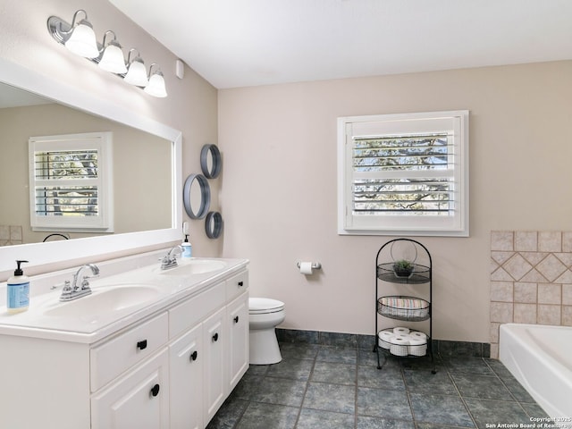 bathroom with a wealth of natural light, toilet, and a sink