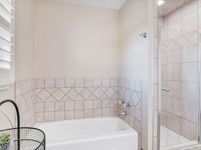 bathroom with a shower stall and a garden tub