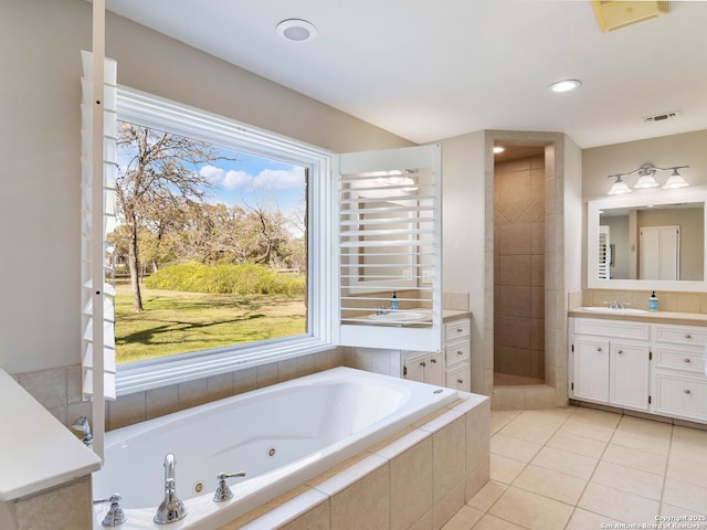 full bath with vanity, visible vents, a whirlpool tub, a tile shower, and tile patterned floors