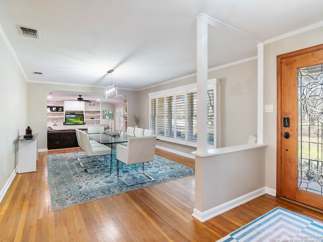 dining space featuring visible vents, ornamental molding, baseboards, and hardwood / wood-style floors