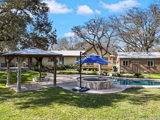 view of home's community featuring a gazebo, a lawn, a jacuzzi, and an outbuilding