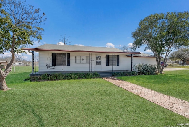 single story home with covered porch, an attached garage, and a front lawn