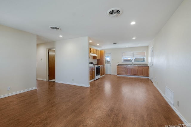 unfurnished living room with visible vents and wood finished floors