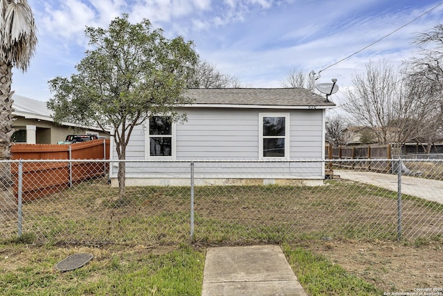 view of property exterior with fence private yard and a yard