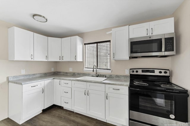 kitchen with appliances with stainless steel finishes, a sink, and white cabinets