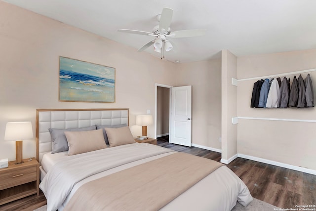 bedroom featuring a ceiling fan, baseboards, and wood finished floors