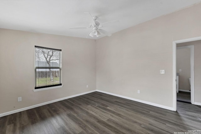 unfurnished room with a ceiling fan, baseboards, and dark wood-type flooring