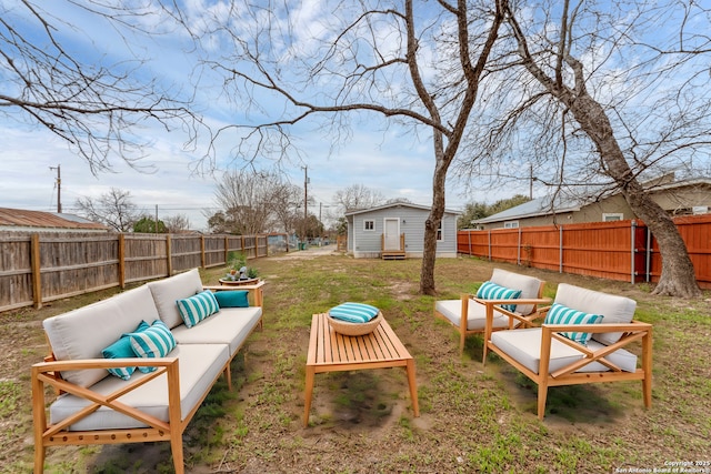 view of yard featuring an outdoor structure, a fenced backyard, and an outdoor living space