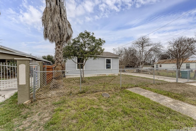 view of yard featuring a fenced front yard and a gate