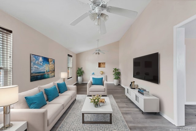 living room with light wood-type flooring, ceiling fan, baseboards, and lofted ceiling