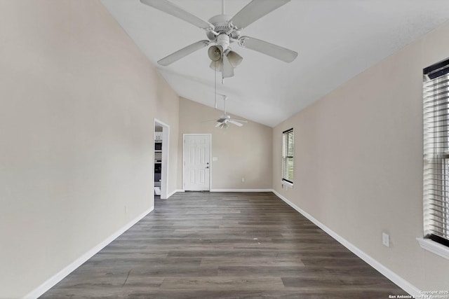 empty room featuring lofted ceiling, ceiling fan, baseboards, and dark wood finished floors