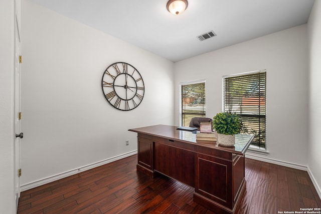 home office featuring dark wood-type flooring, visible vents, and baseboards