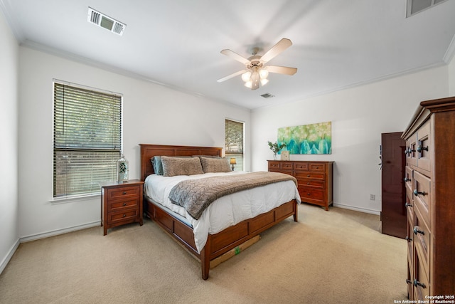 bedroom with light colored carpet, visible vents, crown molding, and baseboards