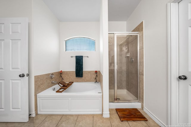 bathroom featuring a stall shower, a garden tub, and tile patterned floors