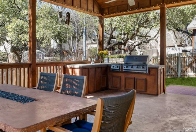 view of patio with fence, grilling area, and area for grilling