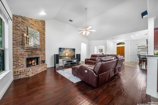 living room featuring a fireplace, wood-type flooring, visible vents, ceiling fan, and high vaulted ceiling