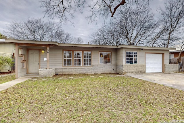 ranch-style house with a garage, driveway, a front lawn, and brick siding