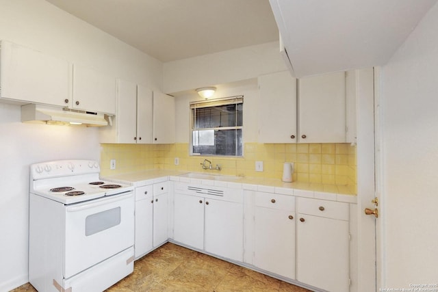 kitchen featuring tile counters, white range with electric cooktop, under cabinet range hood, white cabinetry, and a sink