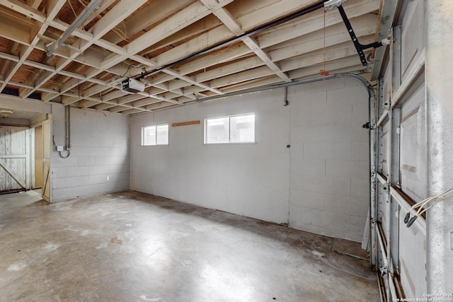 basement featuring a garage and concrete block wall